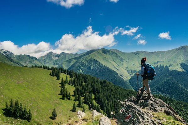 person hiking in front of a mountain